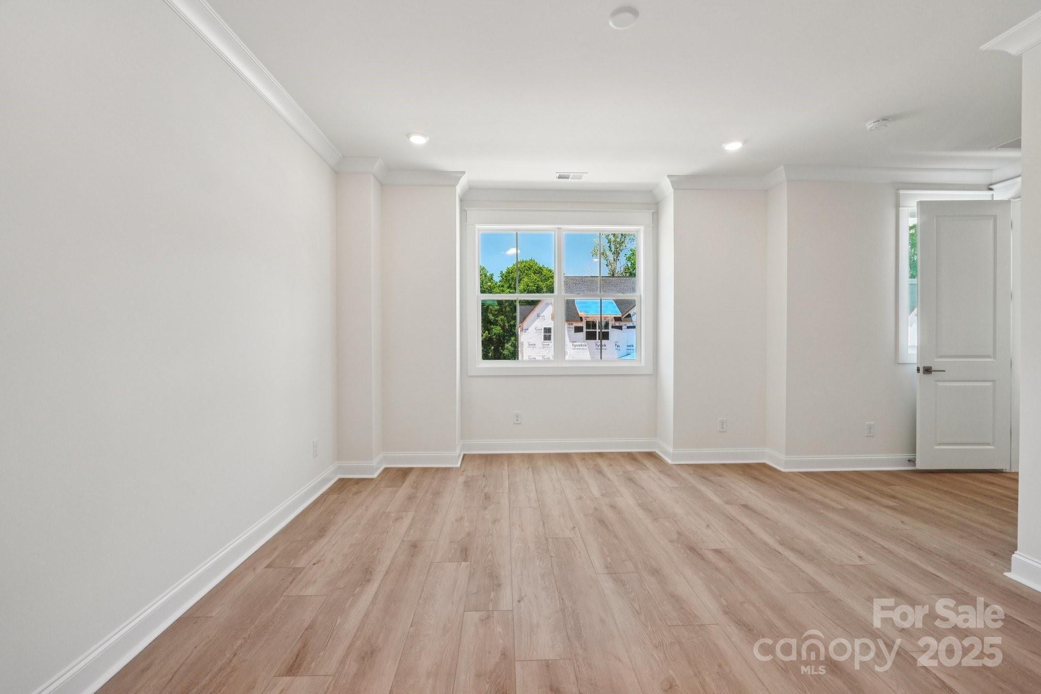 908 Coast Drive Tega Cay, SC 29708 - Photo 8 of 14 wooden floor in an empty room with a window