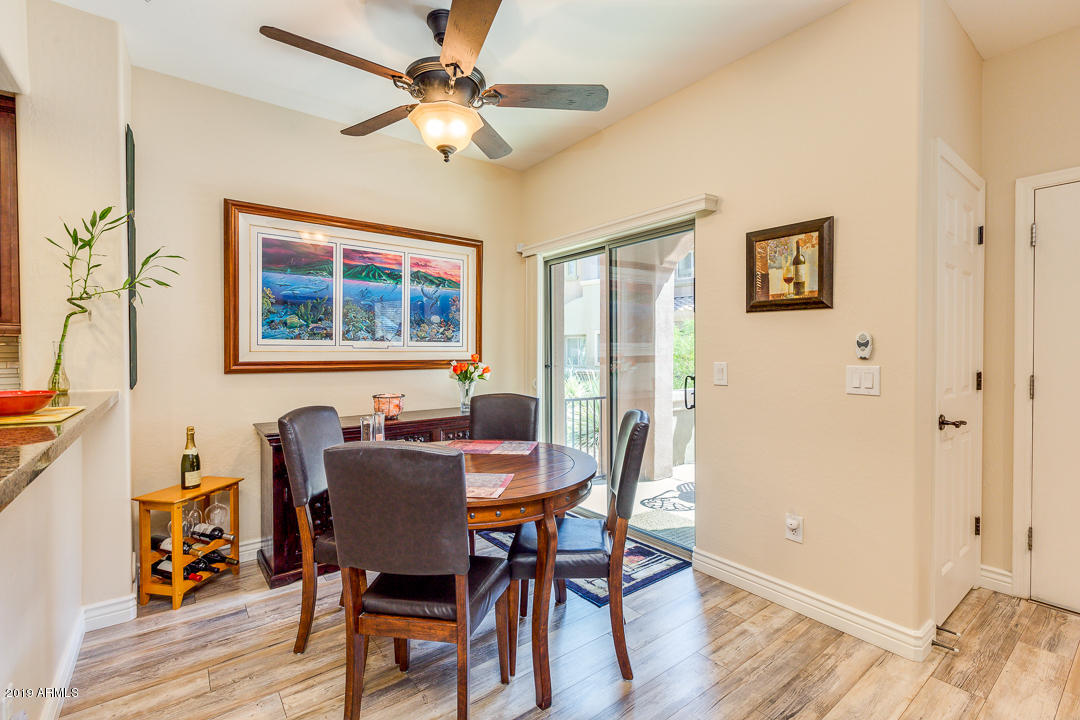 3935 East Rough Rider Road, Unit 1241 Phoenix, AZ 85050 - Photo 11 of 45 a view of a dining room with furniture window and wooden floor