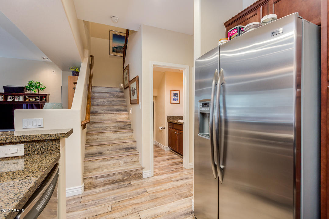 3935 East Rough Rider Road, Unit 1241 Phoenix, AZ 85050 - Photo 16 of 45 a kitchen with granite countertop stainless steel appliances and a counter top space
