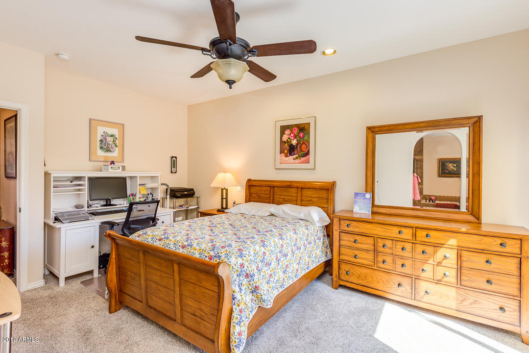 3935 East Rough Rider Road, Unit 1241 Phoenix, AZ 85050 - Photo 22 of 45 a bedroom with a bed and dresser
