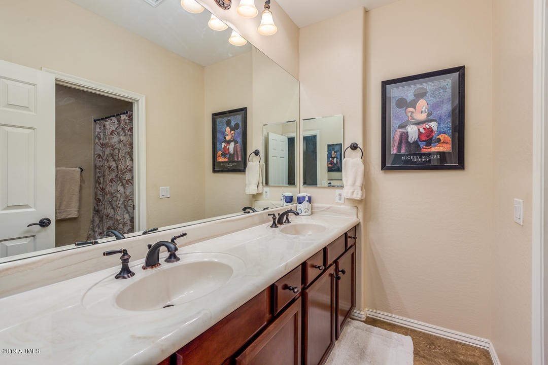 3935 East Rough Rider Road, Unit 1241 Phoenix, AZ 85050 - Photo 28 of 45 a bathroom with a sinks a vanity a mirror and a sink