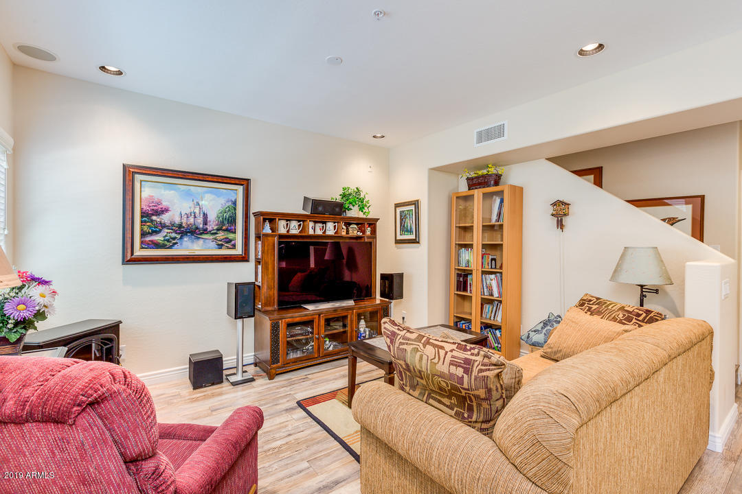 3935 East Rough Rider Road, Unit 1241 Phoenix, AZ 85050 - Photo 7 of 45 a living room with furniture and a flat screen tv