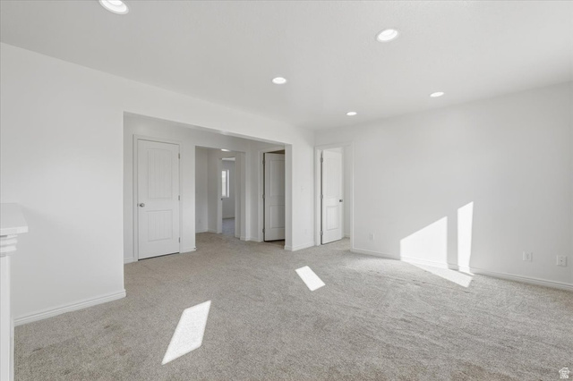 1218 Moonlight Drive Elk Ridge, UT 84651 - Photo 17 of 44 Empty room with recessed lighting and light colored carpet