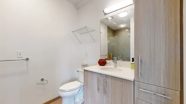a bathroom with a sink and mirror with toilet