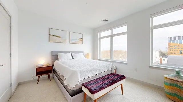 a bedroom with bed and window