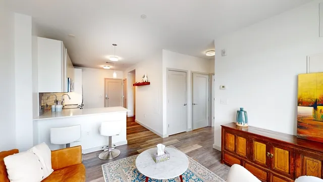 a living room with kitchen island furniture and a wooden floor
