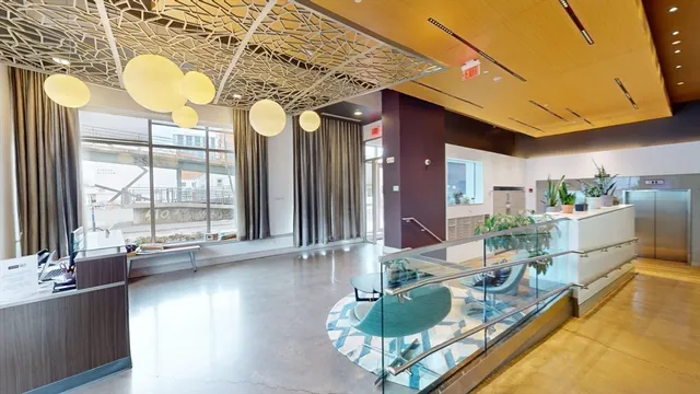 a dining room with furniture and a large window