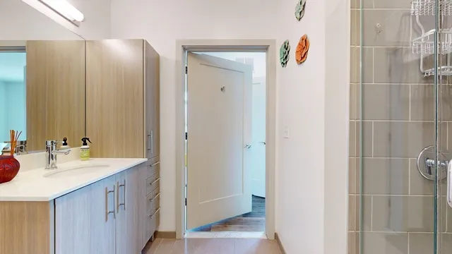 a bathroom with a double vanity sink and mirror