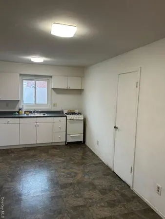 a view of a kitchen with a sink cabinets and window