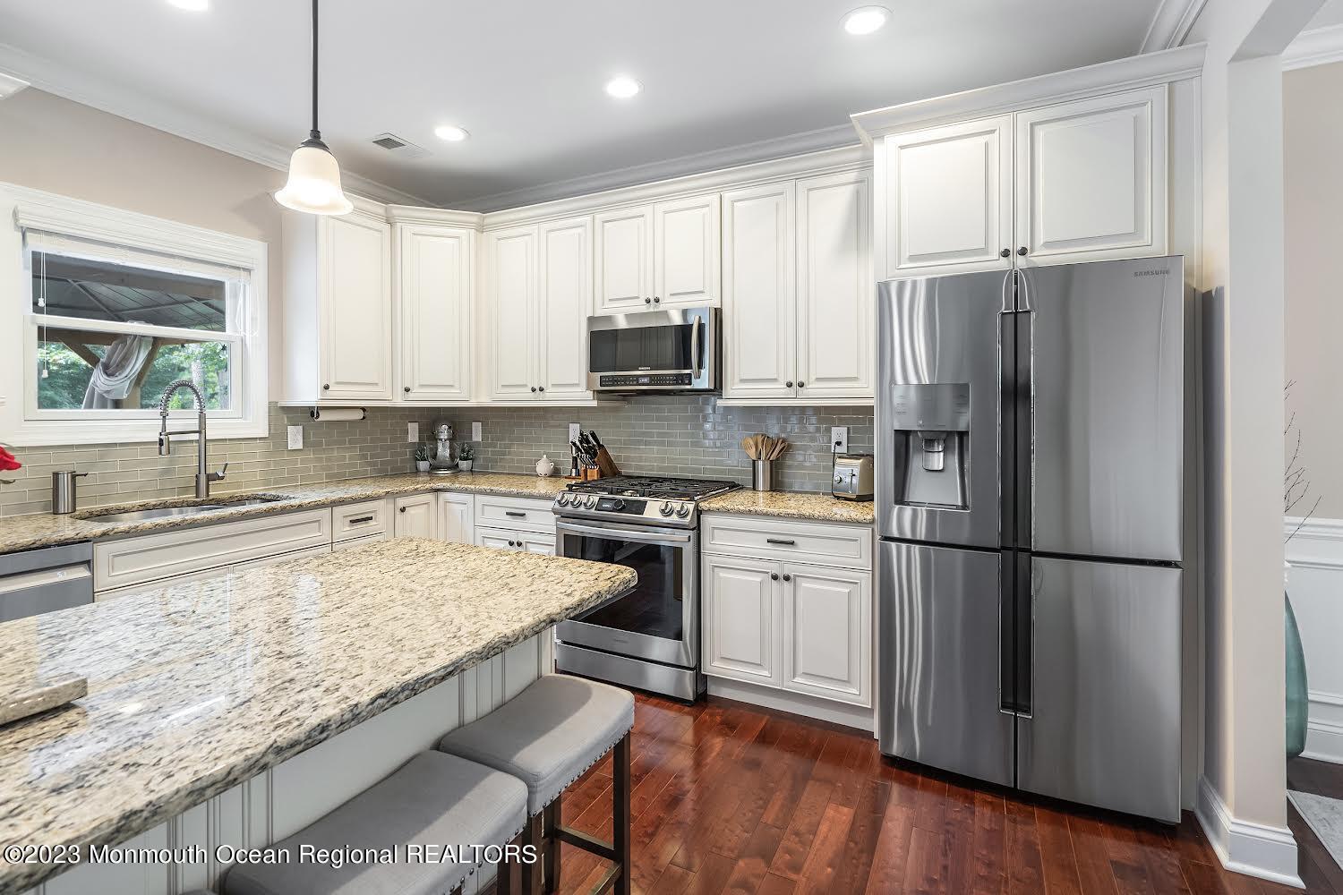 108 Wiseman Road Jackson, NJ 08527 - Photo 11 of 42 a kitchen with granite countertop a refrigerator stove top oven and sink