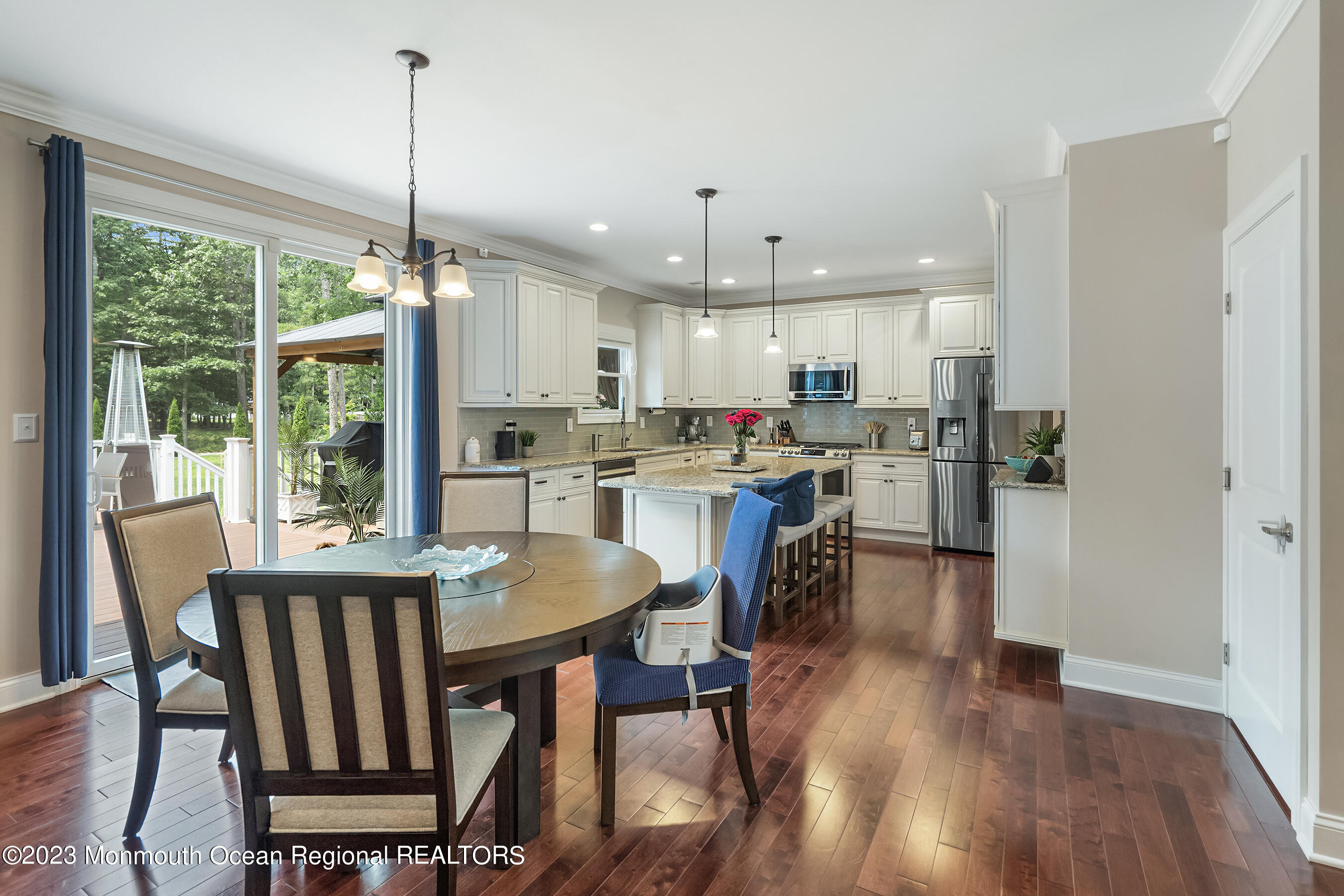 108 Wiseman Road Jackson, NJ 08527 - Photo 16 of 42 a view of a dining room and livingroom with furniture wooden floor a chandelier