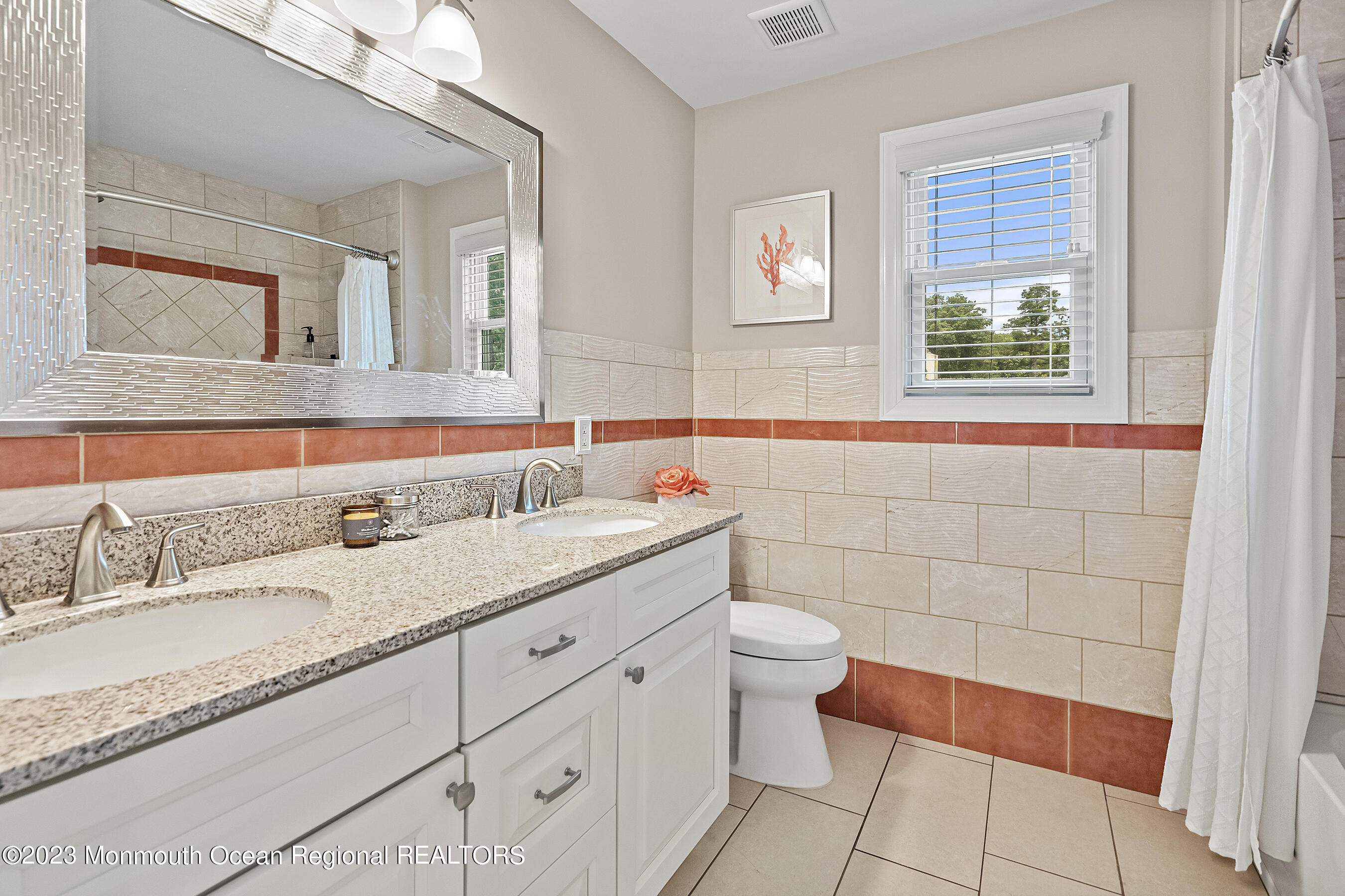 108 Wiseman Road Jackson, NJ 08527 - Photo 26 of 42 a bathroom with a granite countertop sink a toilet a mirror and a shower