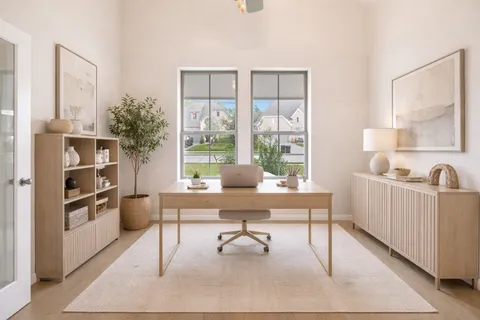 a view of an empty room with a fireplace and a window