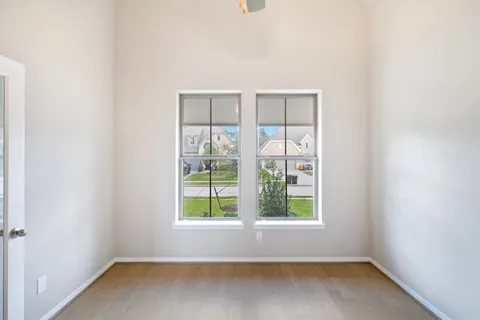 a view of an empty room with wooden floor