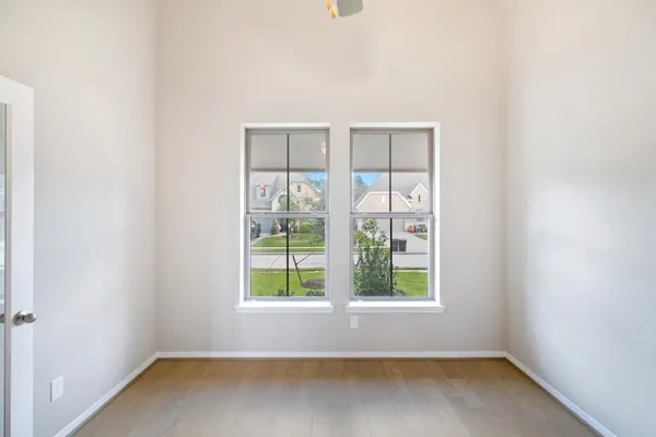 a view of an empty room with a fireplace and a window