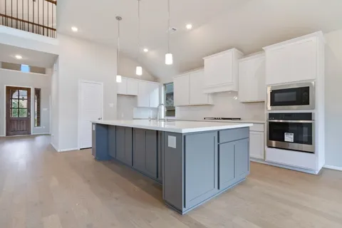 an empty room with windows and entryway