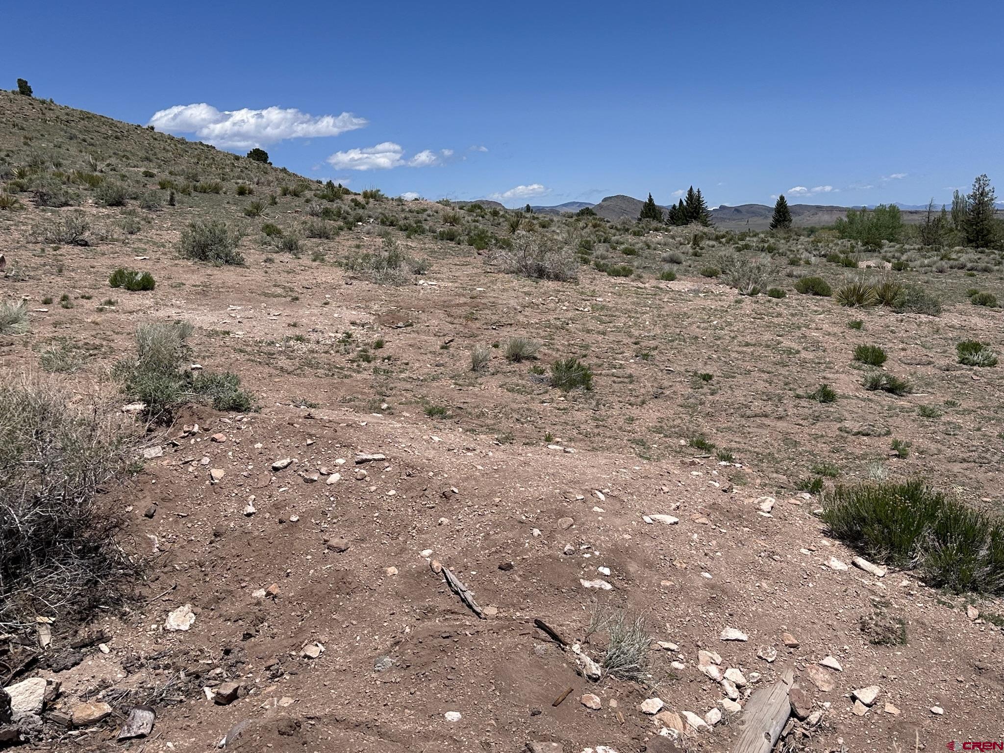 Tbd Tbd Spruce Street Del Norte, CO 81132 - Photo 8 of 44 a view of a dry field with mountains in the background