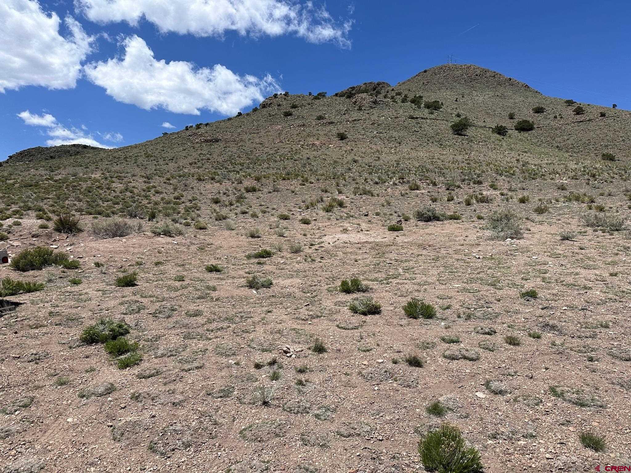 Tbd Tbd Spruce Street Del Norte, CO 81132 - Photo 10 of 44 a view of a dry field with mountains in the background