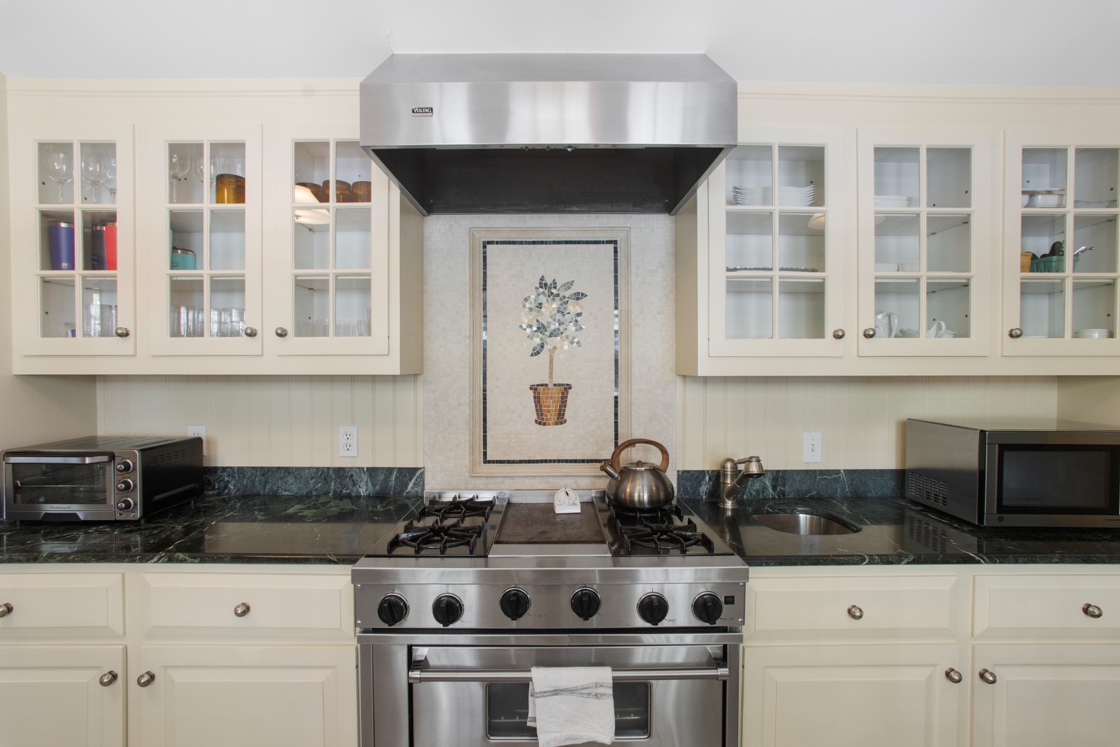 19 Orange Street Nantucket, MA 02554 - Photo 24 of 85 a kitchen with stainless steel appliances a stove and cabinets