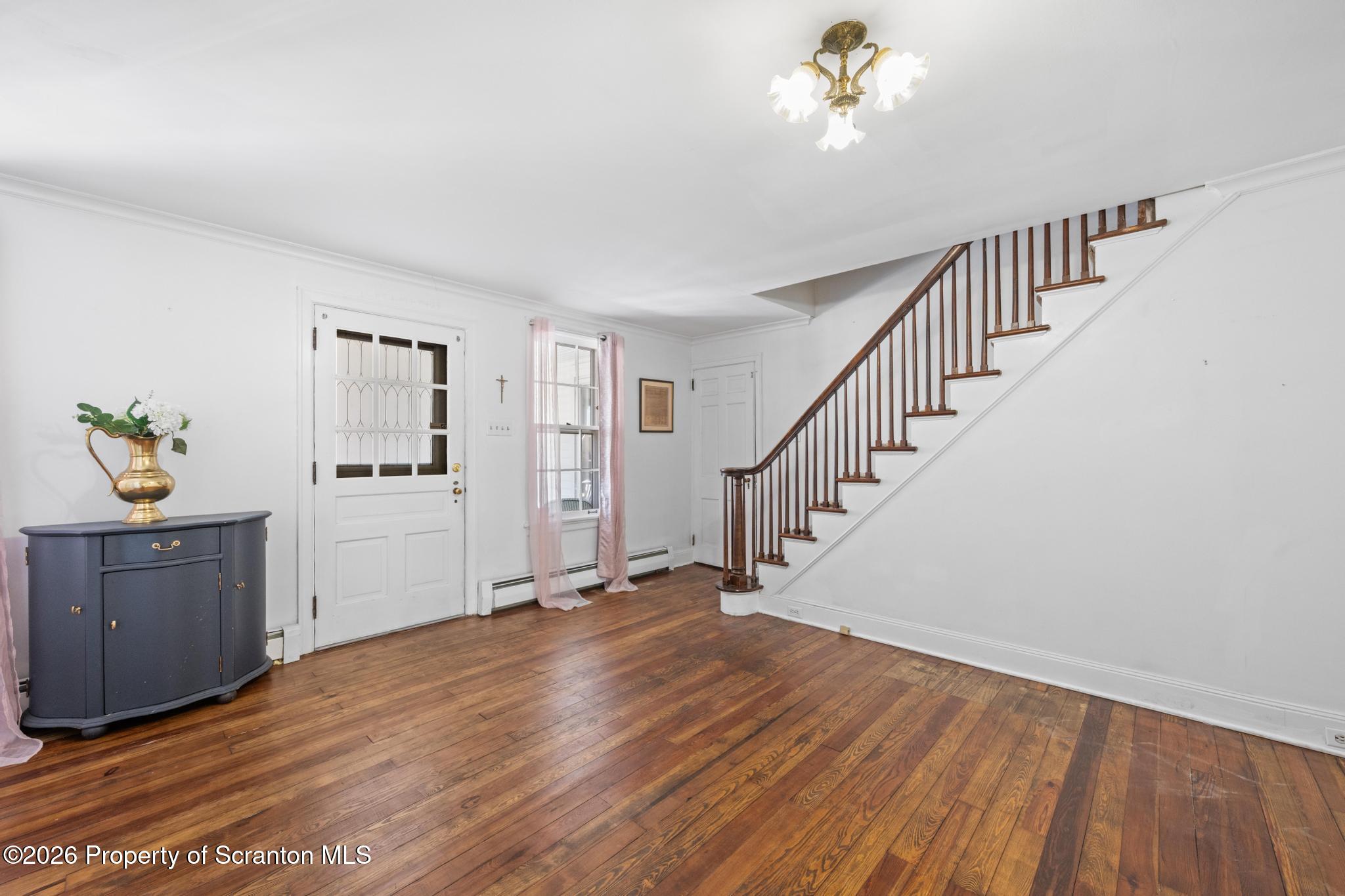 502 Gravel Pond Road Clarks Summit, PA 18411 - Photo 27 of 91 a view of a hallway with wooden floor and staircase