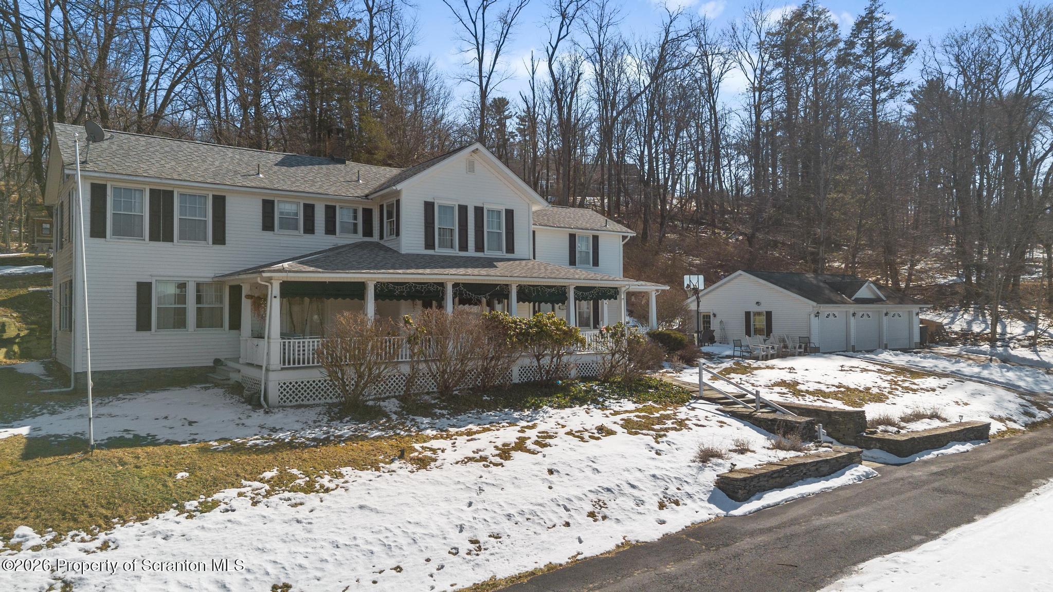 502 Gravel Pond Road Clarks Summit, PA 18411 - Photo 3 of 91 a front view of a house with a yard covered in snow