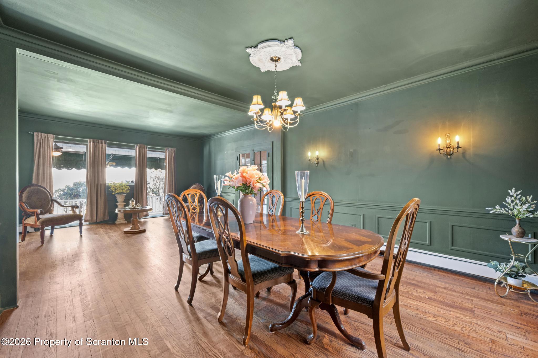 502 Gravel Pond Road Clarks Summit, PA 18411 - Photo 36 of 91 a dining room with furniture a chandelier and wooden floor