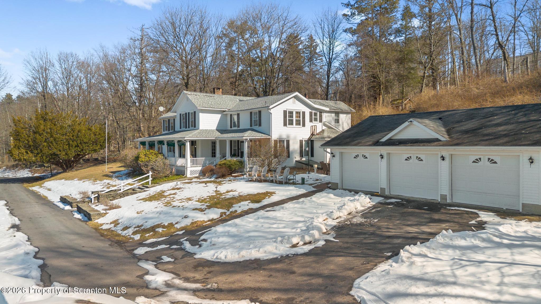 502 Gravel Pond Road Clarks Summit, PA 18411 - Photo 4 of 91 a view of a house with snow on the side of the road