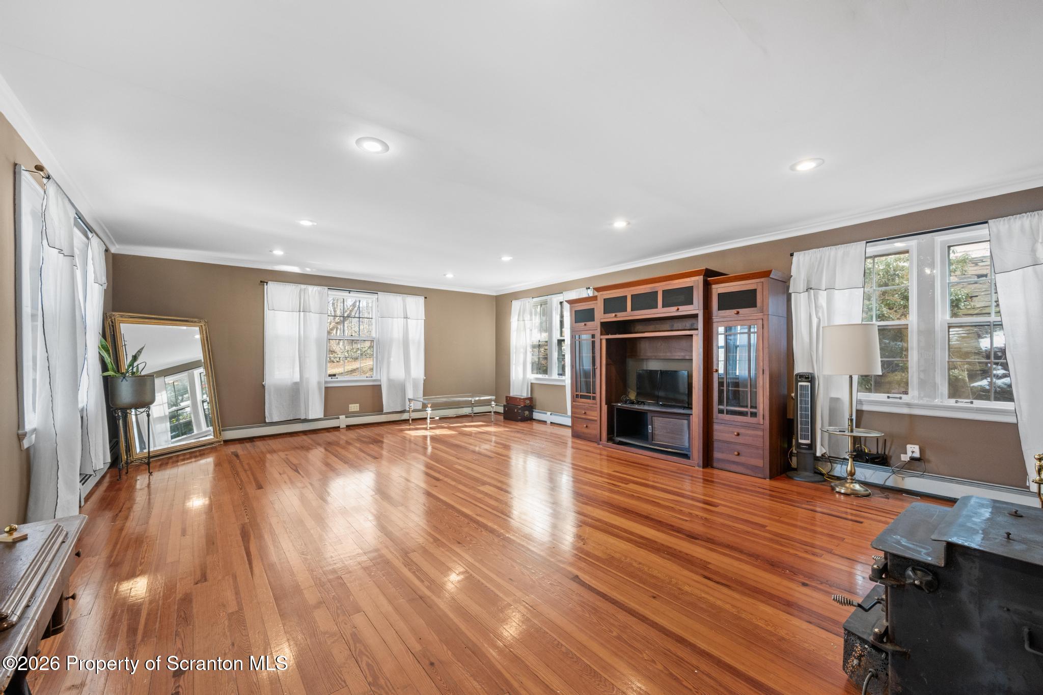 502 Gravel Pond Road Clarks Summit, PA 18411 - Photo 41 of 91 a view of an empty room with wooden floor and a window