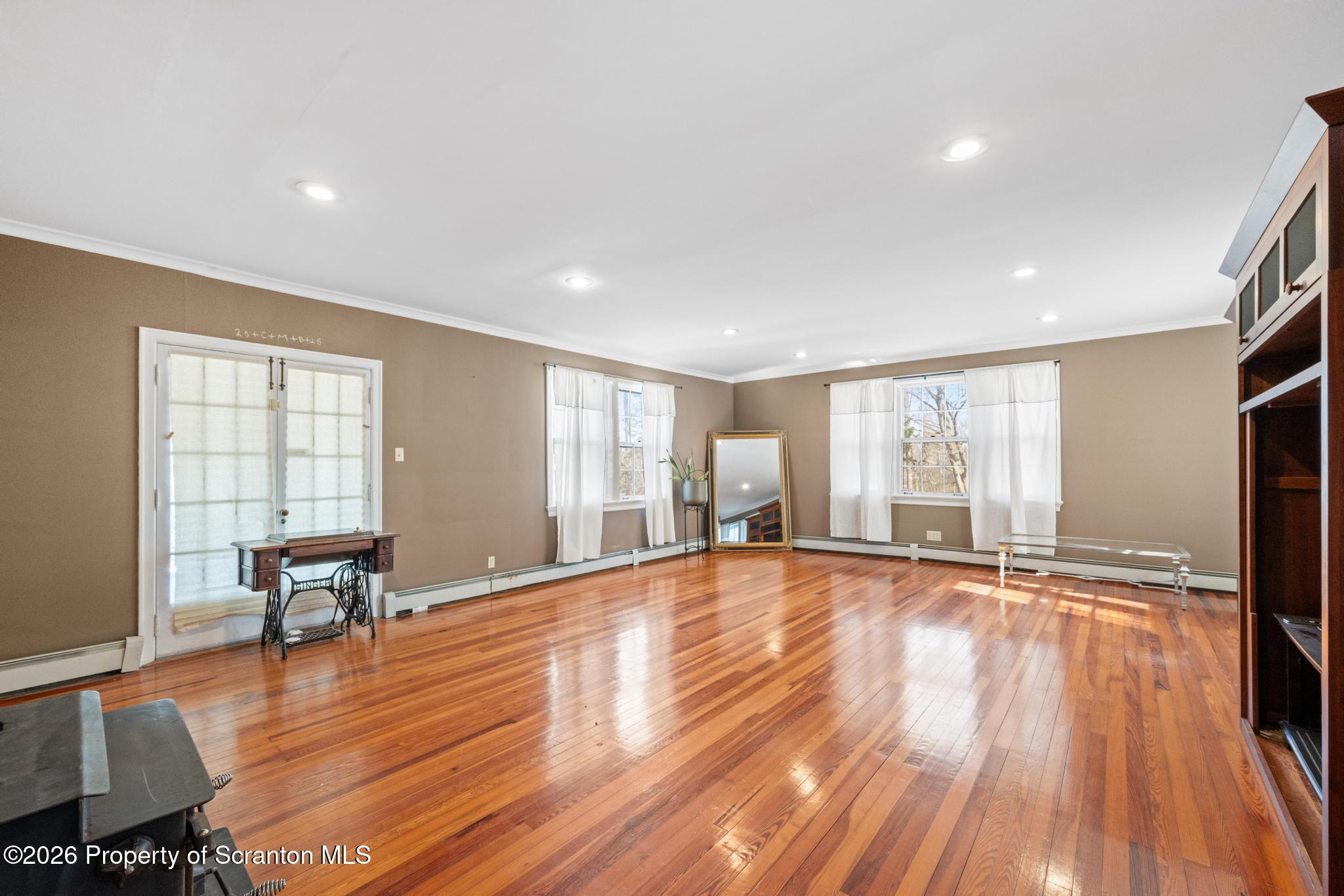 502 Gravel Pond Road Clarks Summit, PA 18411 - Photo 42 of 91 a view of an empty room with wooden floor and a window