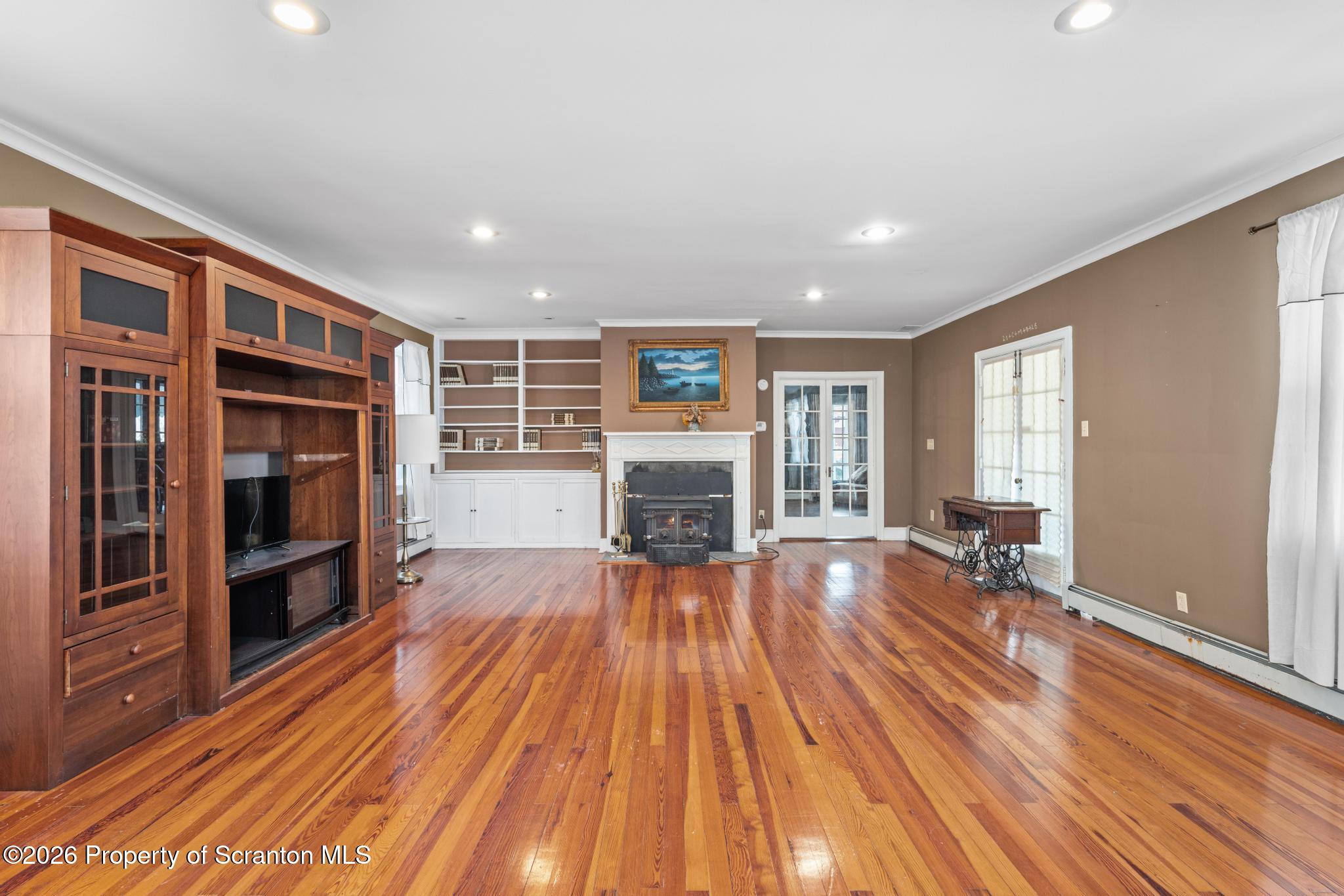 502 Gravel Pond Road Clarks Summit, PA 18411 - Photo 43 of 91 a view of empty room with wooden floor and fireplace
