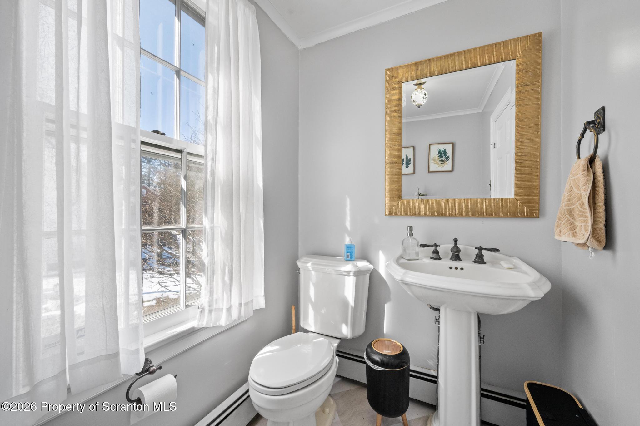 502 Gravel Pond Road Clarks Summit, PA 18411 - Photo 46 of 91 a bathroom with a toilet sink and mirror