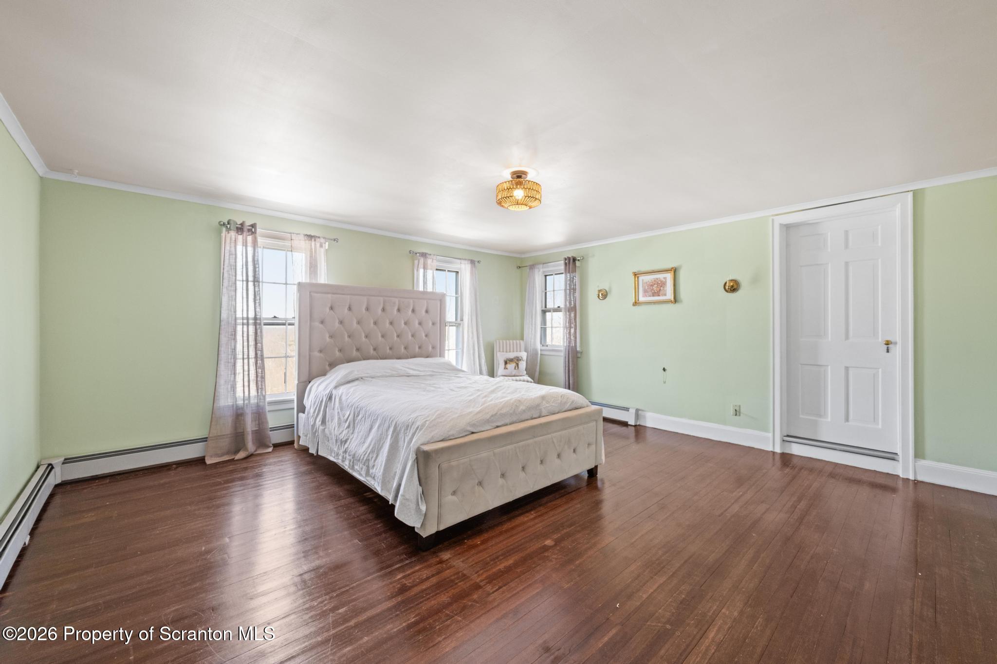 502 Gravel Pond Road Clarks Summit, PA 18411 - Photo 54 of 91 a bedroom with a bed and wooden floor