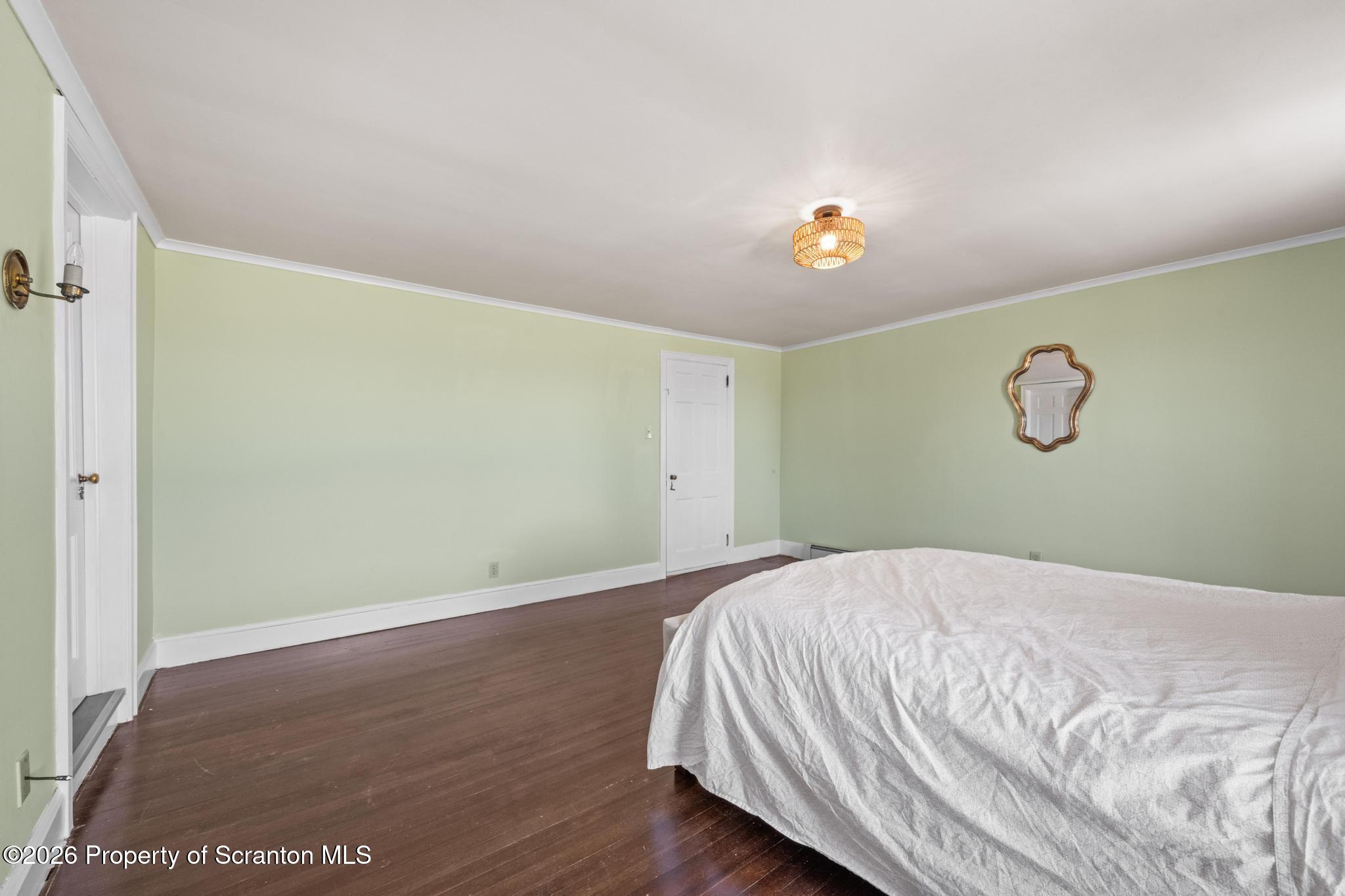 502 Gravel Pond Road Clarks Summit, PA 18411 - Photo 56 of 91 a bedroom with a bed and a chandelier