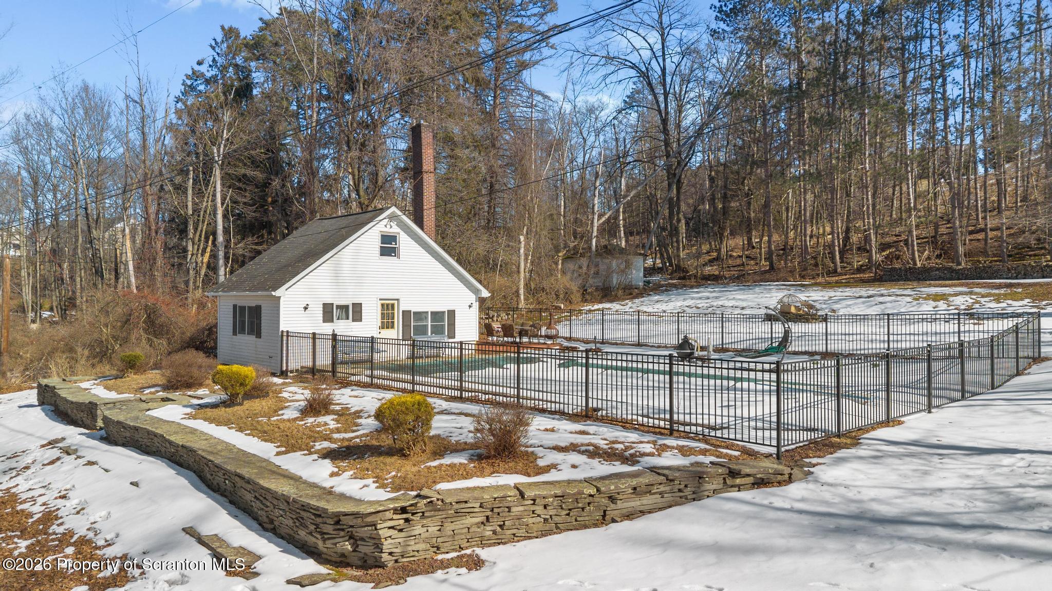 502 Gravel Pond Road Clarks Summit, PA 18411 - Photo 6 of 91 a view of a house with snow on the road