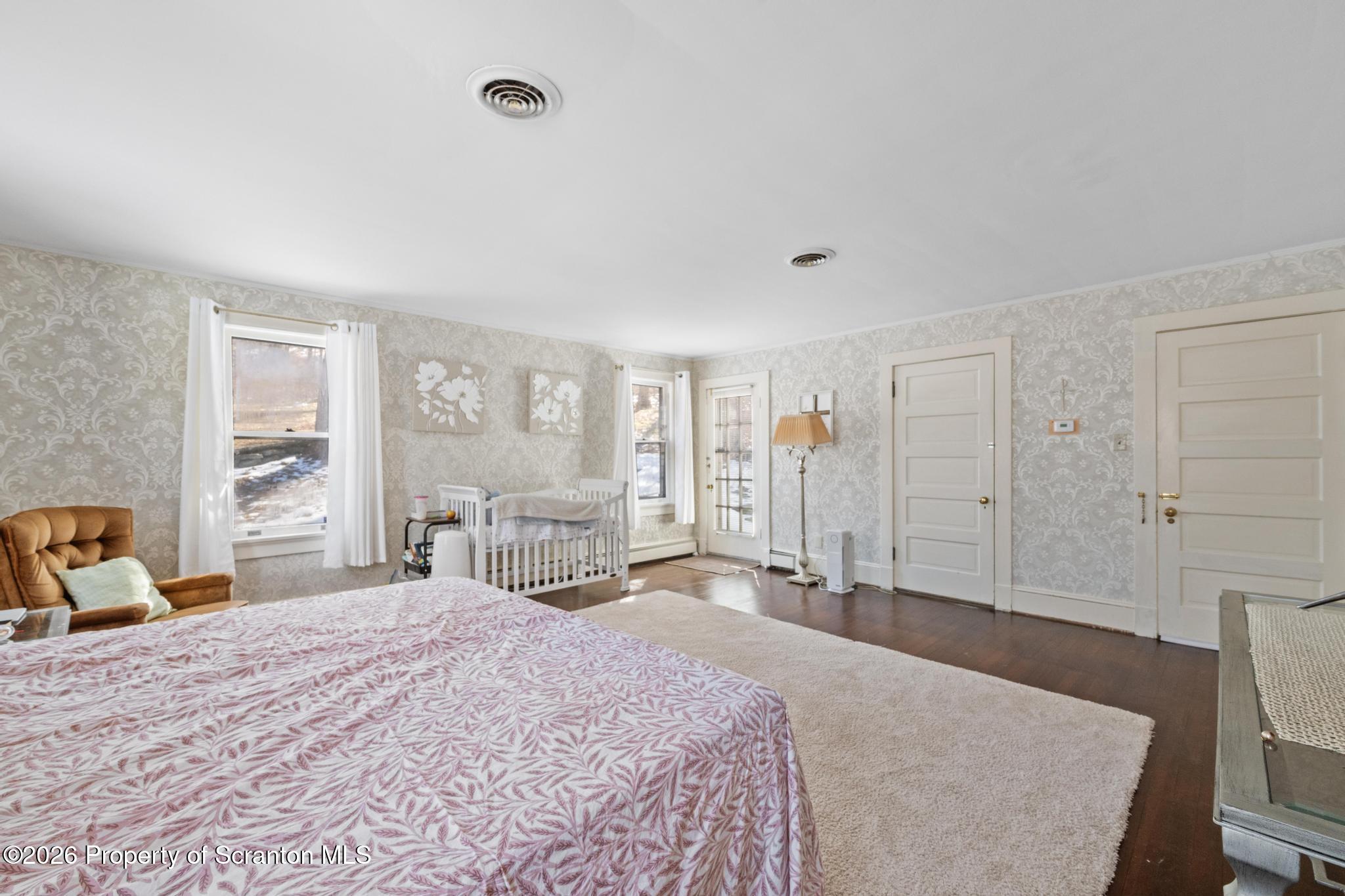 502 Gravel Pond Road Clarks Summit, PA 18411 - Photo 74 of 91 a bedroom with a large bed and a large window