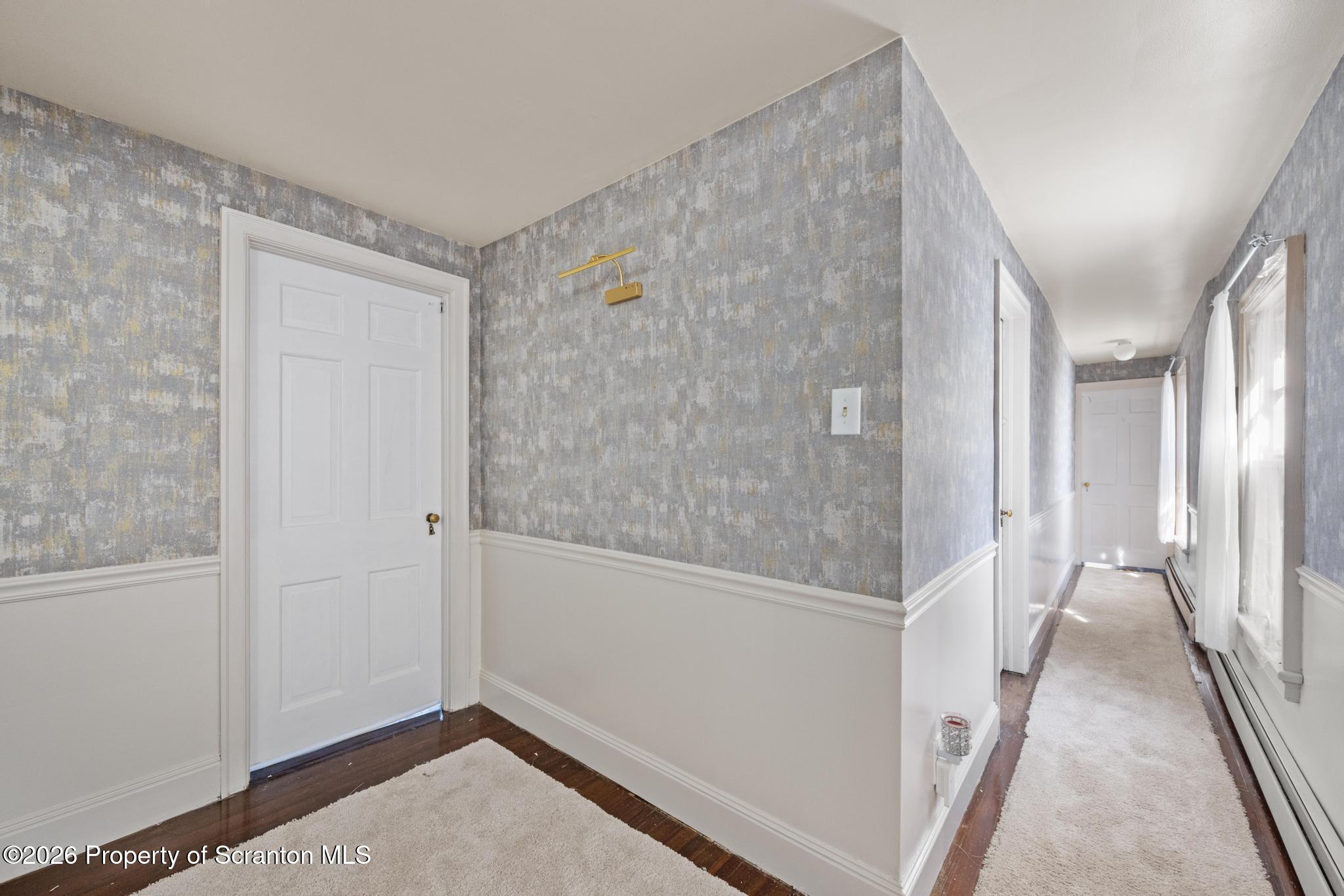 502 Gravel Pond Road Clarks Summit, PA 18411 - Photo 76 of 91 a view of a hallway with wooden floor and staircase