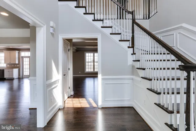 a view of entryway with wooden floor and stairs