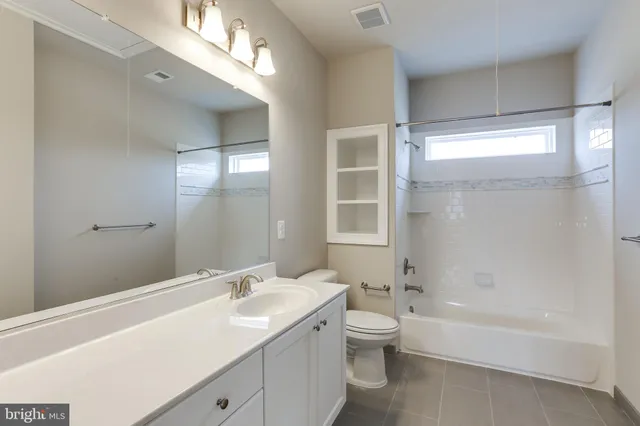 a bathroom with a double vanity sink and mirror