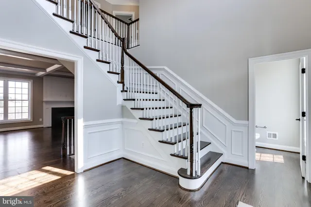 a view of entryway with wooden floor and stair