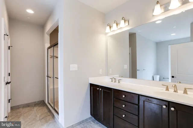 a view of empty room with wooden floor and a fireplace
