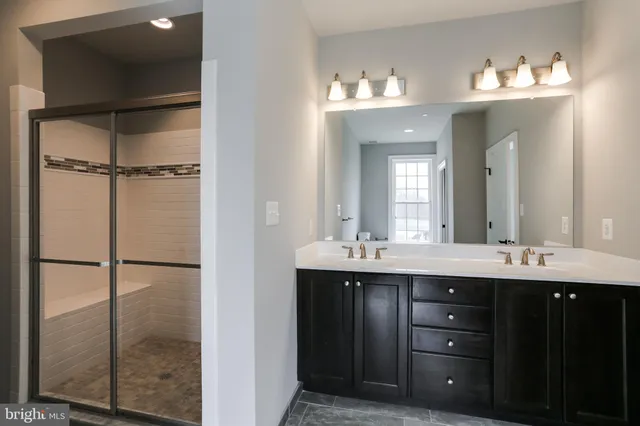 an empty room with wooden floor fireplace and windows
