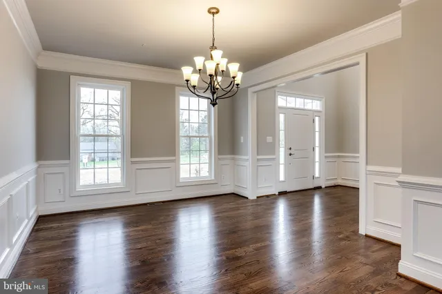 a spacious bathroom with a tub sink and mirror