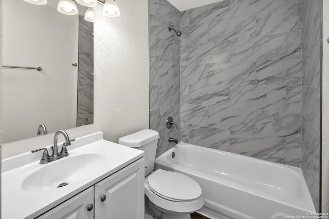 a bathroom with a toilet and a bathtub