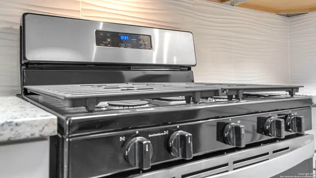 a stove top oven sitting inside of a kitchen