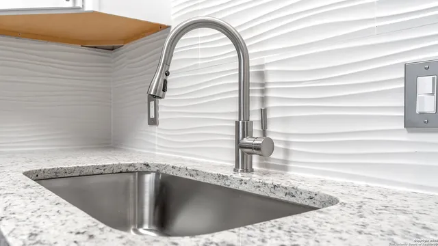 a view of a kitchen with sink and cabinets