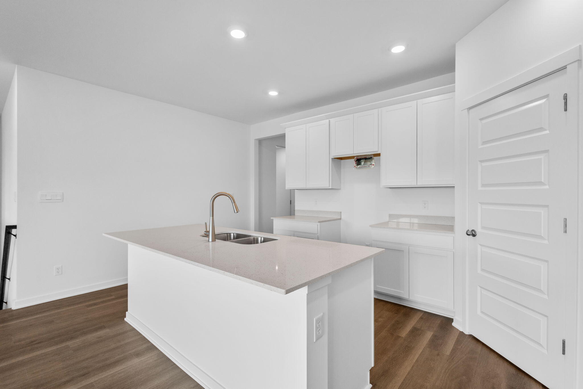 10596 Morse Place Crown Point, IN 46307 - Photo 2 of 16 a kitchen with a sink dishwasher a stove and white cabinets with wooden floor