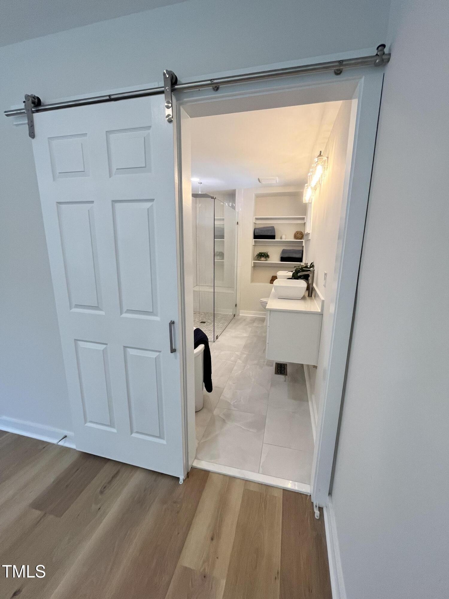 6801 Holly Springs Road Raleigh, NC 27606 - Photo 29 of 34 Barn-style sliding door for master ensuite entry