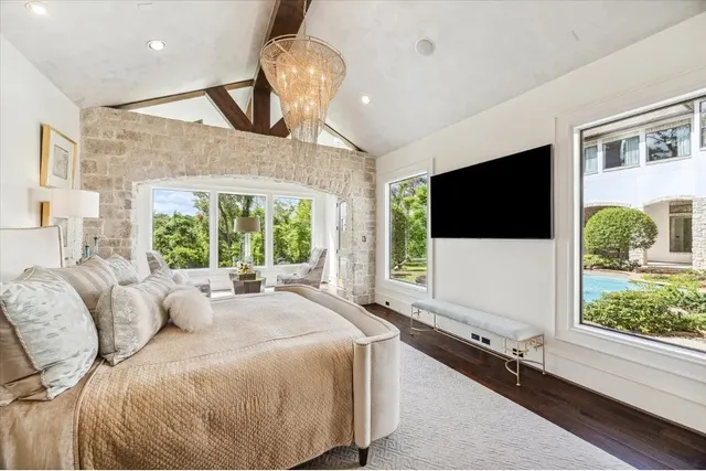 a living room with large window and a flat screen tv