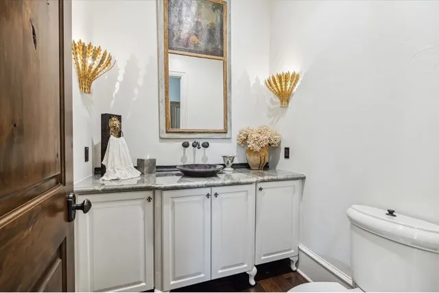 a bathroom with a sink a toilet and mirror