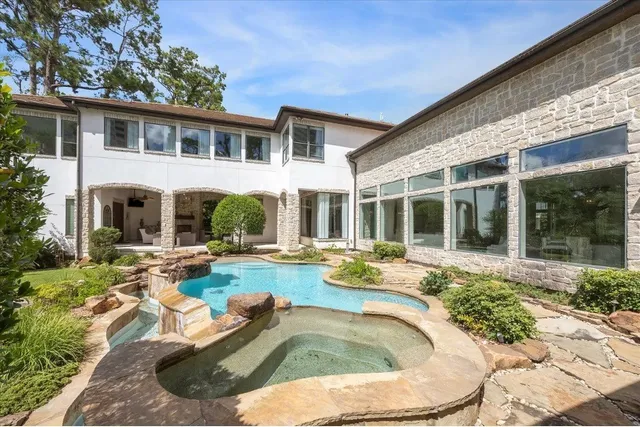 a view of a house with swimming pool and sitting area
